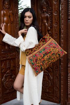 "The beautiful bag is made with an amazing piece of fabric woven by the HMONG hill tribes of Lanna Region (Northern Thailand). Its a great bag for carrying anything. It features a zippered opening area and inside zippered pocket. We buy materials from Hmong market and we design and sew. Some of the bags we modify to improve the product. The Hmong tribes live in the North of Thailand and have origins from the Tibetan area of China. You may not receive the exact bag picture here, As the fabric des Traditional Handwoven Multicolor Embroidered Bag, Bohemian Woven Bags For Festivals, Traditional Multicolor Embroidered Shoulder Bag For Beach, Traditional Rectangular Bags With Multicolor Embroidery, Bohemian Rectangular Embroidered Bag, Festival Embroidered Rectangular Shoulder Bag, Traditional Travel Bag With Woven Motifs, Bohemian Rectangular Bag With Weaving Work, Traditional Embroidered Beach Bags