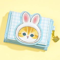 Keep your cards and cash safe by placing them inside this super kawaii trifold wallet! It’s decorated with blue gingham patterns and special illustrations of Usanyan — the Mofusand cat character who loves wearing a rabbit headdress! It has multiple card slots and a spacious coin purse at the back. Made from faux leather Features a trifold shape and a metal cat charm Comes with a snap button and zipper closures Cute Blue Wallet With Card Slots, Cute Blue Rectangular Wallet, Cute Blue Wallets For Gift, Cute Blue Wallets For Gifts, Kawaii Wallet, Cash Safe, Cat Wallet, Kawaii Bags, Metal Cat