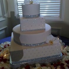 a three tiered wedding cake sitting on top of a table