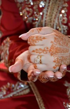 a close up of a person's hands with hennap on their fingers