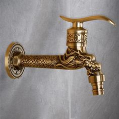 a golden faucet with a dragon head on it