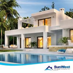 a house with a swimming pool in front of it and palm trees around the pool