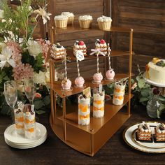 desserts and cupcakes are displayed on the table