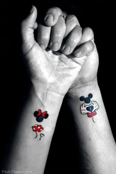 two wrist tattoos with mickey and minnie mouses on them