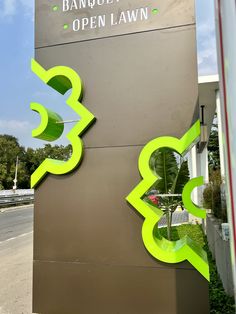 the entrance to an office building with neon green letters on it's front and side