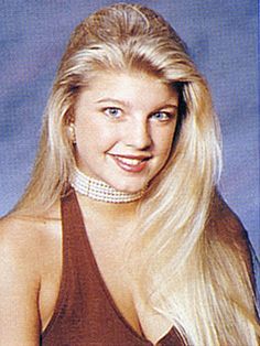 a woman with long blonde hair wearing a halter top