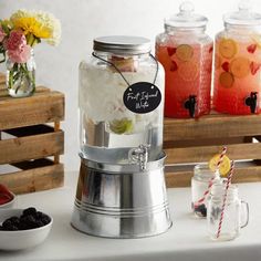 a table topped with jars filled with different types of drinks