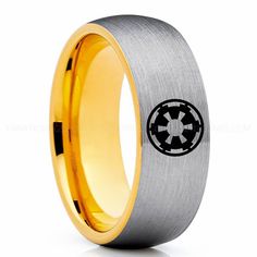 the star wars symbol is engraved on this men's gold and silver wedding band