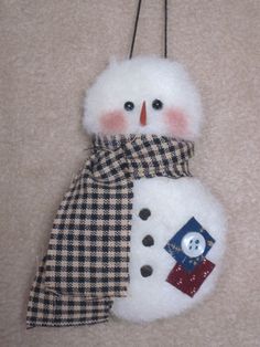 a snowman ornament hanging on a wall