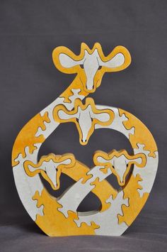 a wooden sculpture with yellow and white designs on it