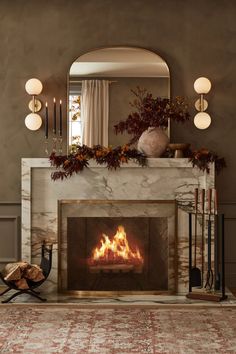 a living room with a fire place in the middle and candles on the fireplace mantel