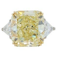 Platinum and 18 kt yellow gold engagement ring featuring a center (FIY VS2) 23.88 ct Radiant cut yellow diamond(GIA# 5161984914) with 1.56 cts tw of trilliant diamonds on the sides Yellow Diamond Ring, Yellow Diamonds Engagement, Yellow Diamond Rings, Fancy Yellow Diamond, Jewelry Appraisal, Trendy Fashion Jewelry, Jewelry Rings Diamond, Gorgeous Jewelry, Yellow Diamond