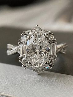 an oval cut diamond ring with baguettes on the side