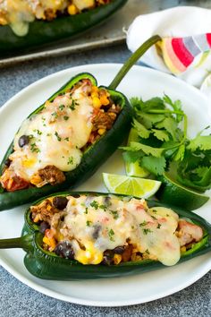 two green peppers stuffed with mexican food and garnished with cilantro leaves