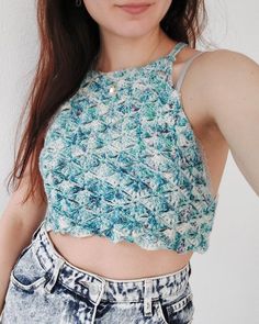 a woman with long brown hair wearing a crop top