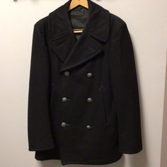 Authentic Us Navy Issue Pea Coat Vintage 1980's Size 36s. 100% Wool. The Person Who This Coat Was Issued To, Served In The Pacific Fleet, So Rarely Had The Need Or Opportunity To Wear This Coat. The Coat Secures By One Interior And Three Exterior Buttons, As Well An Additional Button Near Collar Where Lapel Can Be Secured For Additional Warmth. Also Three More Matching Decorative Buttons On The Front. Side Pockets And A Right Side Interior Pocket. Coat Has Been Stored Covered In A Non-Smoking, Pet Free Home. See Photos. Approximate Measurements Laid Flat: Shoulder To Hem: 30" Arm Pit To Arm Pit: 22" Sleeve Length: 25" Retro Double-breasted Outerwear With Button Closure, Retro Double-breasted Winter Blazer, Vintage Double Button Winter Blazer, Vintage Winter Blazer With Double Button Closure, Vintage Pea Coat With Pockets For Workwear, Vintage Style Pea Coat With Pockets For Work, Winter Retro Double-breasted Blazer, Vintage Outerwear With Double Button And Lapel Collar, Vintage Double-breasted Pea Coat With Pockets