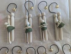 several wooden pegs are tied together with string and star shaped hair clips on them