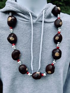 This necklace is a fun spin off of the classic Buckeye necklace.  This would be the perfect necklace to wear to the Skull session to see the band play before the game.  You will fit right in at any tailgate party, hanging with family and friends, or if you are lucky watching the game at the Shoe.   This necklace features a scarlet, skull, and gray metallic bead pattern.   What makes this a great necklace is that it features 14 high quality, Columbus grown Buckeyes (Ranked # 1).  That is 2-4 more Ohio Buckeyes, Ohio State Buckeyes Football, Buckeyes Football, Bead Pattern, Tailgate Party, Skull Necklace, Ohio State Buckeyes, Ohio State, Columbus