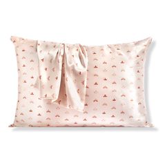 a pink pillow with a bow on the front and back of it, sitting on a white surface