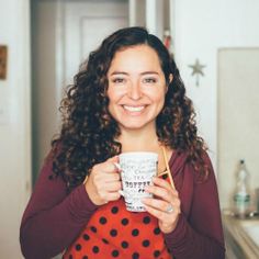 a woman holding a coffee cup in her hands