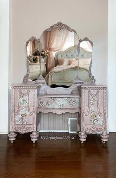 an ornate pink dresser with mirror and bed