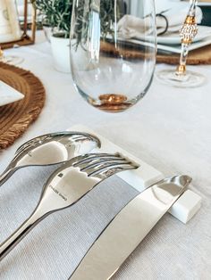 there are forks and spoons on the table