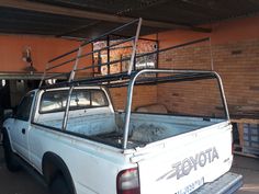 an old pick up truck is parked in a garage with its flat bed on the back