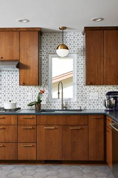 a kitchen with wooden cabinets and stainless steel appliances