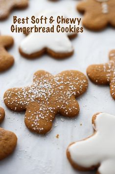 gingerbread cookies with icing and powdered sugar are arranged on a baking sheet