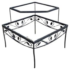 a metal bed frame with an intricate design on the top and bottom, in black