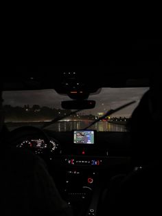 the interior of a car at night with lights on