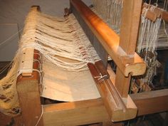 an old weaving machine is being worked on