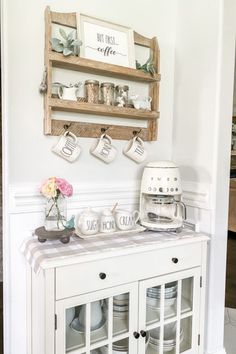 a white hutch with coffee mugs on it