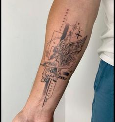 a man's arm with a cross and an eagle tattoo on the left forearm