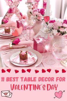 the table is set for valentine's day with pink flowers and hearts on it