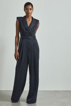 Find ATELIER Anabella Cupro Belted Tux Jumpsuit on Editorialist. Made from a lyocell-linen blend, the Anabella jumpsuit has a silky cupro finish and a premium drape against the skin. Its double-breasted front, corset-style stitching, and soft padded shoulders set a confident mood, and it's cinched with a self-fabric belt. Italian lyocell-linen cupro fabrication Double-breasted front Padded shoulders Corset-style stitching Self-fabric belt Side pockets Front pleats Wide leg Reiss Atelier is an effortlessly chic collection of timeless wardrobe staples and occasion pieces that can be worn - and loved - for many years Jumpsuit With Belt, Satin Jumpsuit, Dressing Gown Robe, Timeless Wardrobe, Beachwear Skirt, Timeless Wardrobe Staples, Cover Beachwear, Jumpsuit Online, Denim Coat Jacket