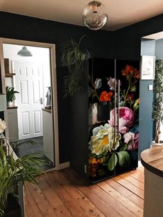 a kitchen area with a refrigerator covered in flowers