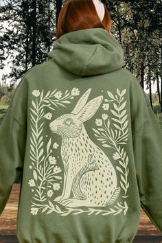 Embrace your inner granola girl with this stunning linocut Bunny Hoodie! #LinocutShirt #bunnyhoodie #GranolaGirl #rabbithoodie #forestcore Cotton Hoodie With Screen Print For Spring, Spring Cotton Hoodie With Screen Print, Spring Hoodie With Screen Print In Relaxed Fit, Spring Hoodie With Screen Print And Relaxed Fit, Relaxed Fit Hoodie With Screen Print For Spring, Relaxed Fit Screen Print Hoodie For Spring, Casual Hooded Hoodie With Screen Print, Cozy Hooded Sweatshirt With Graphic Print, Hooded Hoodie With Screen Print For Fall