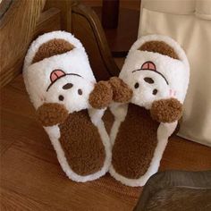 two slippers that are on top of each other in the shape of animals with eyes and nose