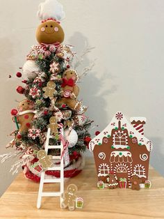 a christmas tree with gingerbread house and ginger cookies