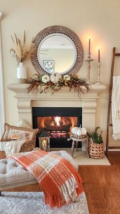 a living room filled with furniture and a fire place next to a mirror on the wall