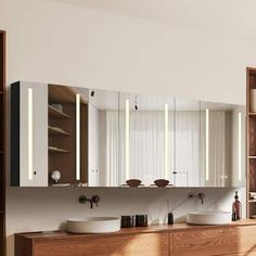 a bathroom with two sinks and wooden cabinets