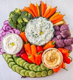 a platter filled with vegetables and dip