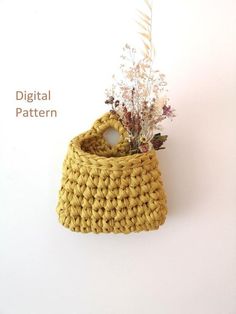 a crocheted basket with flowers in it on a white wall next to the words digital pattern