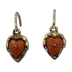 This is a gorgeous pair of Victorian Coral Heart Dangle Drop Earrings in 10 Karat Gold. The wonderful dangle drop earrings have delicate hand carved coral hearts. The hearts are set in a repousse engraved heart setting in 10 Karat yellow gold. The color of the coral is a warm lovely salmon which the Victorians treasured. The size is absolutely wonderful. It is so rare to find antique Victorian Coral drop earrings! The coral earrings date to circa 1850-1900. What a perfect pair to wear everyday o Vintage Gold Heart Earrings, Red Vintage Heart Earrings For Gifting, Vintage Heart Dangle Earrings, Red Vintage Heart Earrings, Carved Red Vintage Jewelry, Victorian Drop Earrings, Coral Drop Earrings, Gold For Sale, Earrings Antique