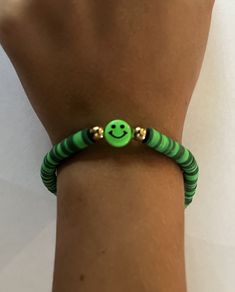 "Smiley Green", as Grace describes it, is one of her many bracelets she's making.  Clay beads are threaded onto high test fishing line tied together for a semi-stretch component, but don't pull too hard! 😜Green plastic smiley face for a fun look.  Very unique gift for any daughter, niece or granddaughter! Green Resizable Beaded Bracelets For Friendship, Fun Green Friendship Bracelets With Round Beads, Fun Green Round Beads Friendship Bracelets, Green Fun Friendship Bracelets With Letter Beads, Fun Green Friendship Bracelets With Letter Beads, Casual Adjustable Smiley Face Friendship Bracelets, Fun Adjustable Green Beaded Bracelets, Fun Green Beaded Bracelets For Friendship, Casual Adjustable Smiley Face Bracelets