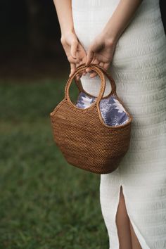 The Sanibel Bag is carefully and consciously handwoven by artisans in Bali, Indonesia using local and sustainable materials. No two bags are alike. Each bag is lined with a unique batik-patterned fabric. Body: organic ata grass Interior: lined with organic 100% cotton colorful batik-patterned fabric Large handles for easy carry Drawstring top-close Dimensions Top length = 33cm / 11in Bottom length = 18cm / 7in Width = 18cm / 7in Height = 33cm / 13in Eco-friendly Everyday Bags With Bamboo Handle, Eco-friendly Bag With Bamboo Handle, Eco-friendly Bags With Bamboo Handle For Everyday, Eco-friendly Bag With Bamboo Handle For Everyday Use, Everyday Natural Fiber Bucket Bag With Bamboo Handle, Bohemian Bags With Bamboo Handle, Traditional Bag With Bamboo Handle For Everyday Use, Traditional Bags With Bamboo Handle For Everyday Use, Everyday Woven Bags With Round Handle