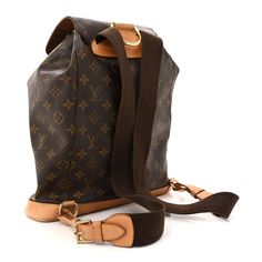 This is an authentic LOUIS VUITTON Monogram Montsouris GM Backpack. This backpack is crafted of classic Louis Vuitton monogram coated canvas with vachetta leather accents, including a solid base, faux belt closure, cinch cord, and trim. The straps are a combination of fabric and adjustable vachetta leather. The bag features a front zipper pocket and top D-ring loop. The foldover flap opens to a cocoa brown fabric interior with a patch pocket. Cocoa Brown, Leather Accents, Brown Fabric, D Ring, Authentic Louis Vuitton, Front Zipper, Louis Vuitton Monogram, Patch Pocket, Zipper Pocket