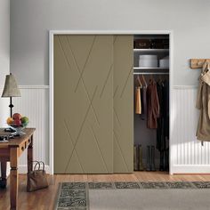 an open closet with clothes hanging on the wall and coat rack in front of it