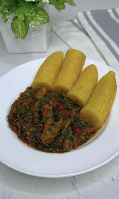 a white plate topped with cut up bananas next to some green vegetables on top of it